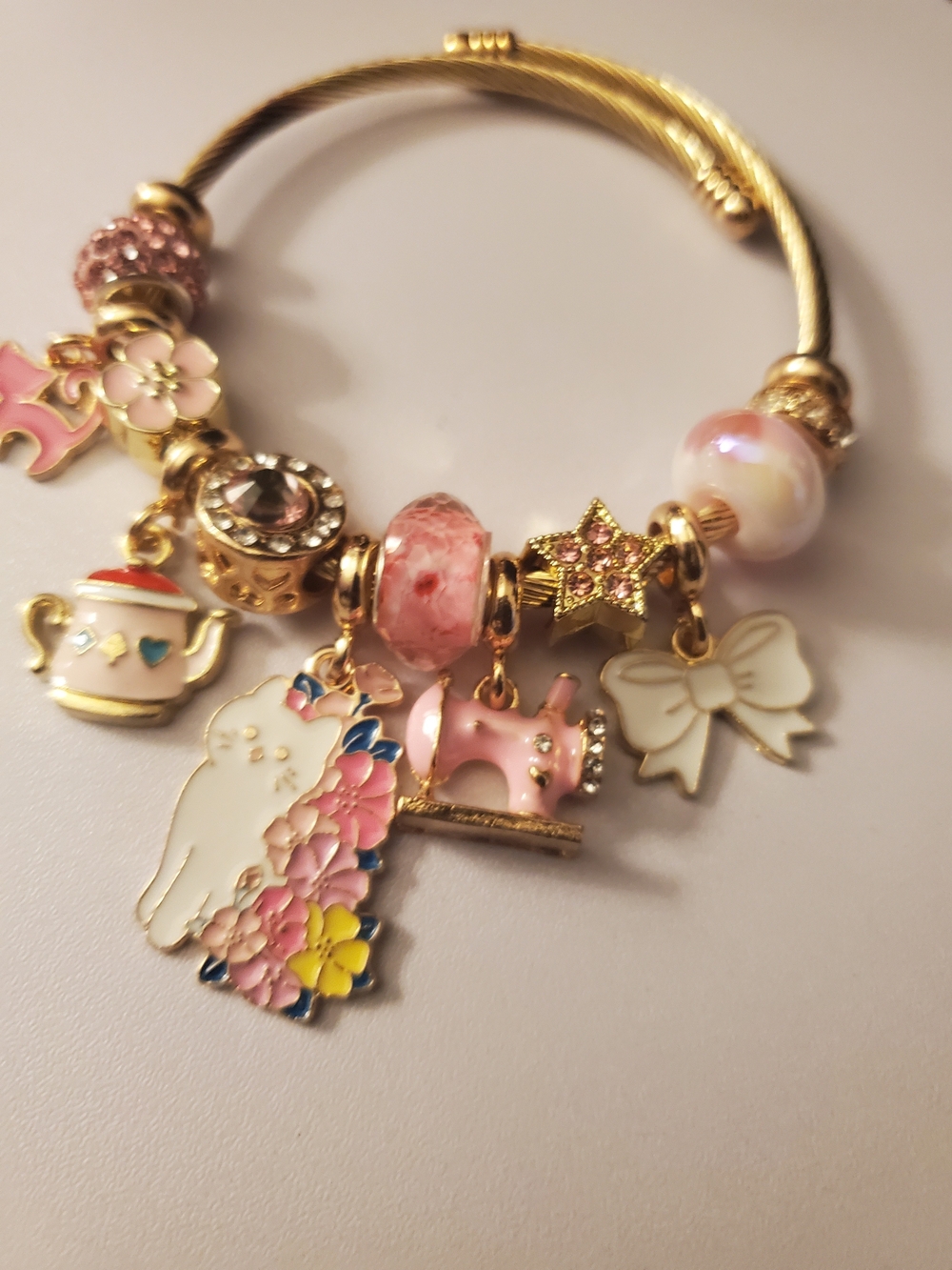 Gold-Tone Pink Charm Bracelet with Floral Cat and Sewing Charms